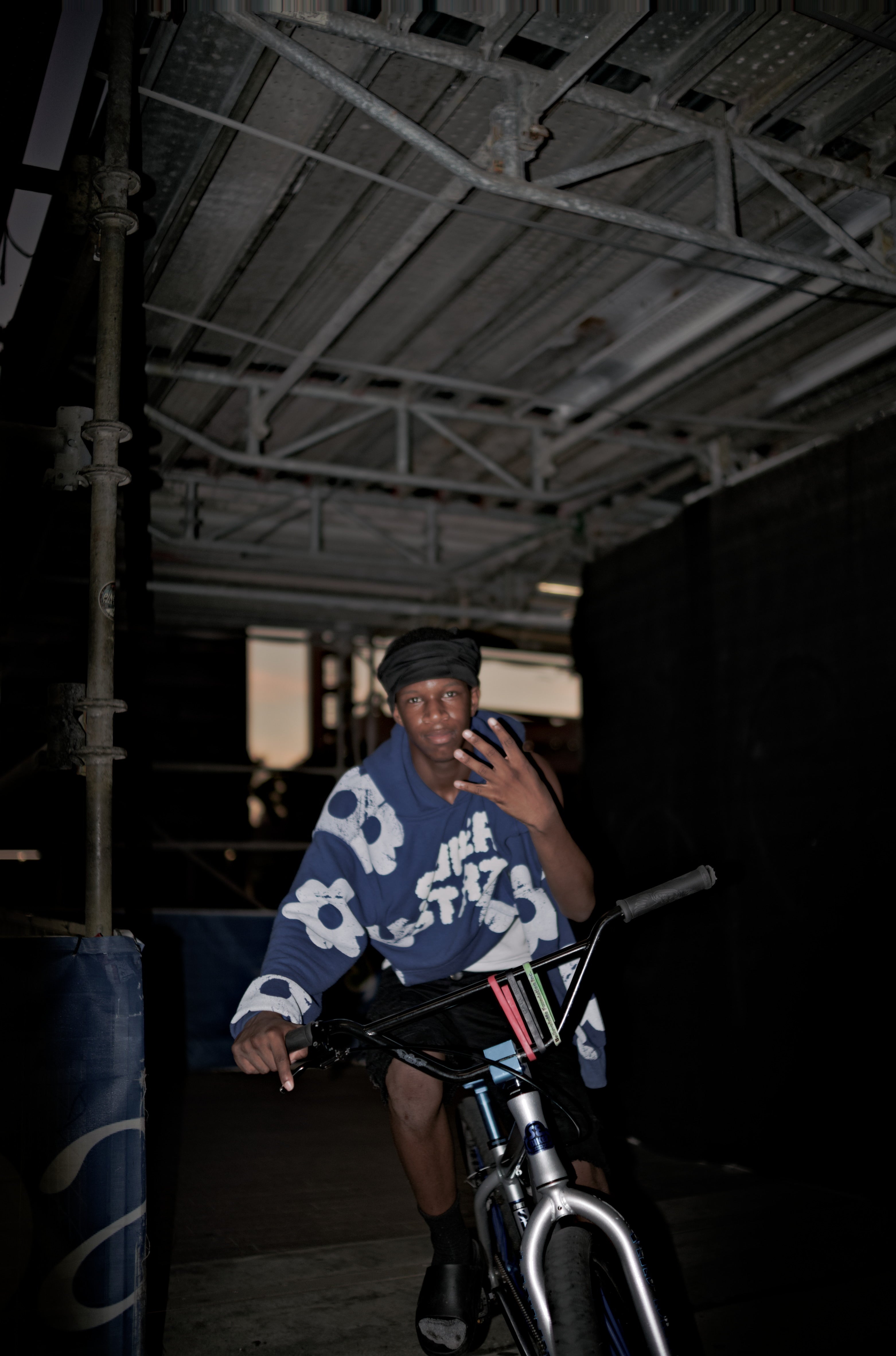 Person sitting on a bicycle in a dark indoor setting. Acacia Cinematography, Tampa, Fl 